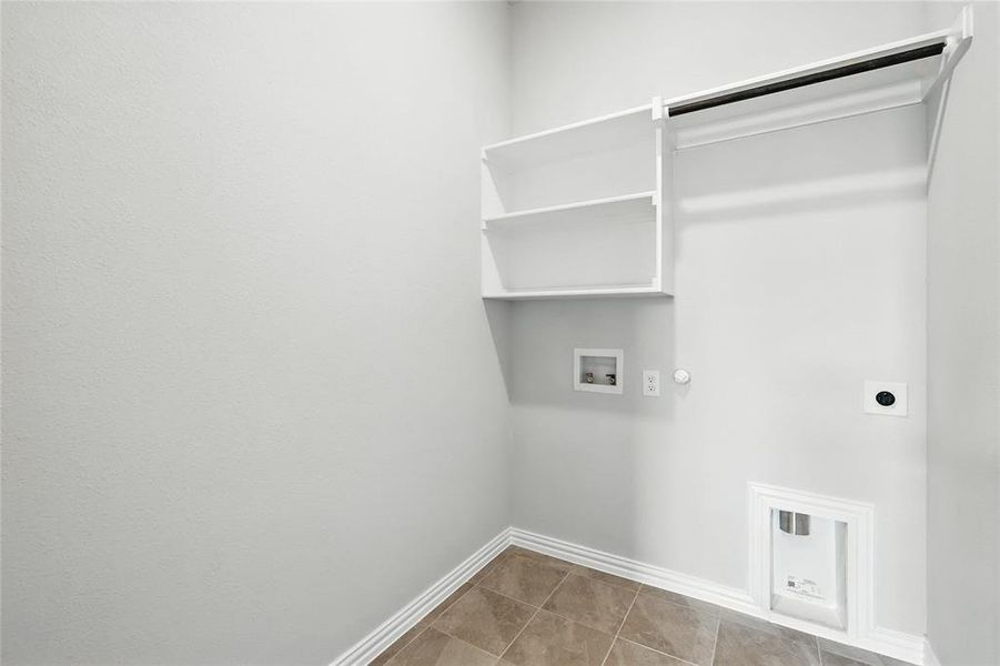 Laundry room with hookup for a gas dryer, hookup for a washing machine, hookup for an electric dryer, and light tile patterned floors