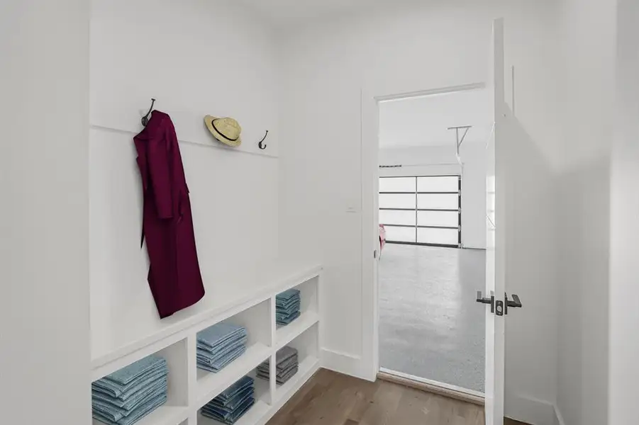 Mudroom with wood finished floors and baseboards