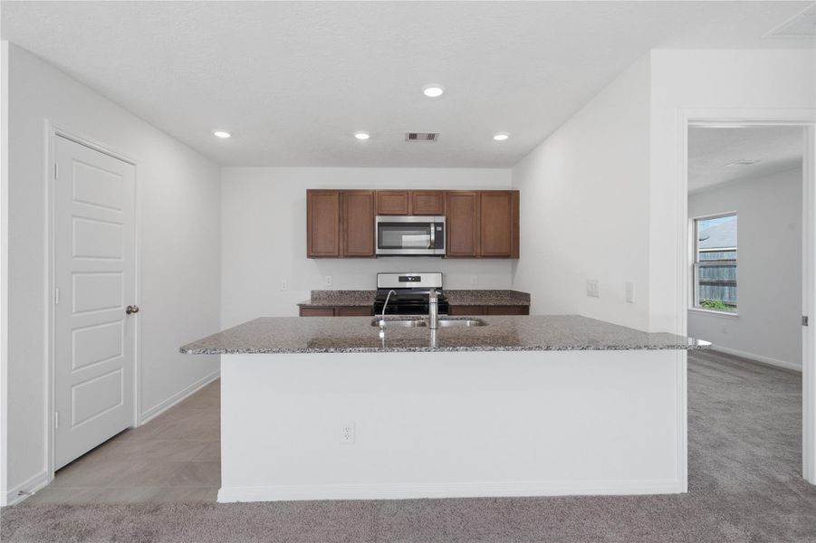 Stunning open-concept design seamlessly connecting the living, dining, and kitchen areas—perfect for both everyday living and entertaining!