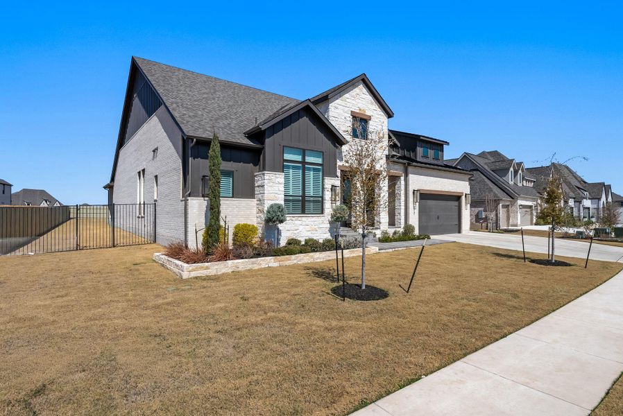 Front exterior of a new home in Santa Rita Ranch, Liberty Hill, TX, highlighting curb appeal (Image 1). Front exterior of a new home in Santa Rita Ranch, Liberty Hill, TX, highlighting curb appeal (Image 1).