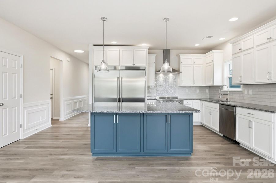 Engage your inner chef in the Gourmet Kitchen, which boasts sleek stainless steel appliances, a center island, granite counters, and a spacious dining area