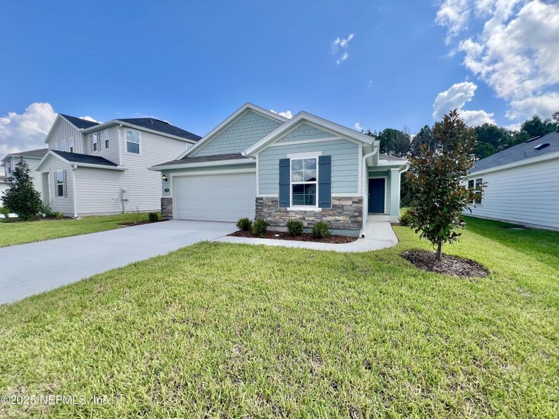 Front exterior of a new home in Panther Creek, Jacksonville, FL, highlighting curb appeal (Image 1). Front exterior of a new home in Panther Creek, Jacksonville, FL, highlighting curb appeal (Image 1).