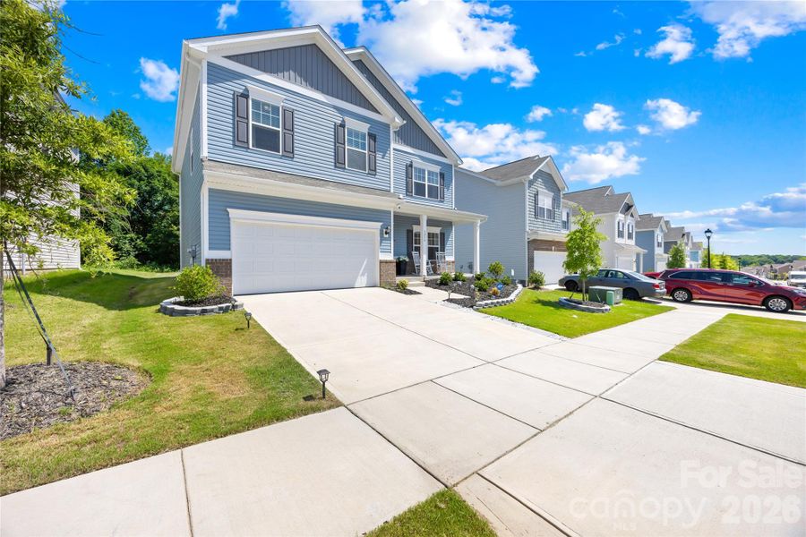 Front exterior of a new home in Orchard Creek, Charlotte, NC, highlighting curb appeal (Image 23).