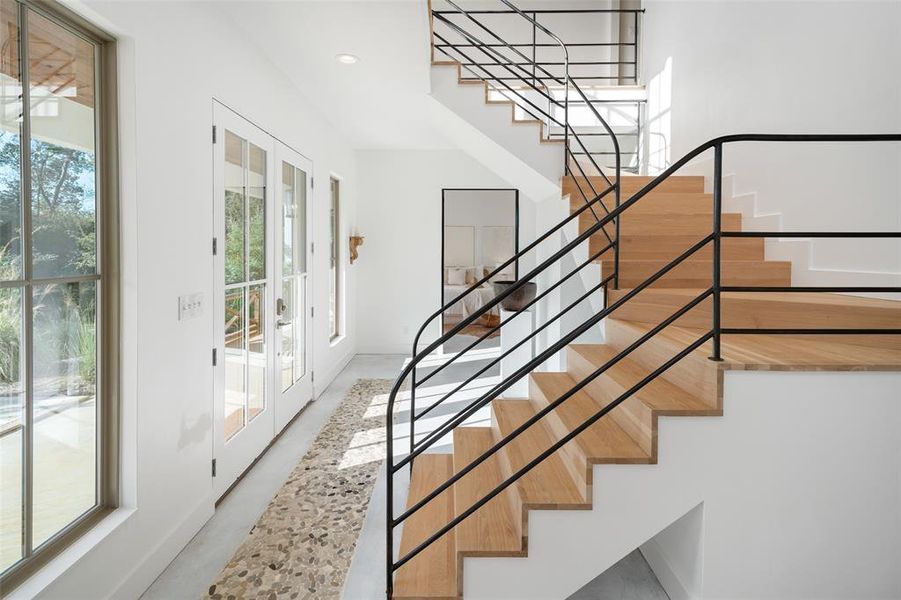Stairway featuring french doors Stairway featuring french doors