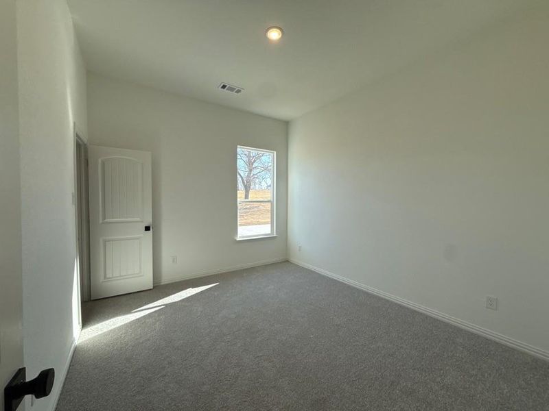 Carpeted empty room featuring baseboards and recessed lighting