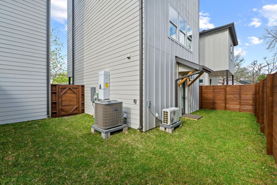 View of side of property with a gate, a fenced backyard, and board and batten siding