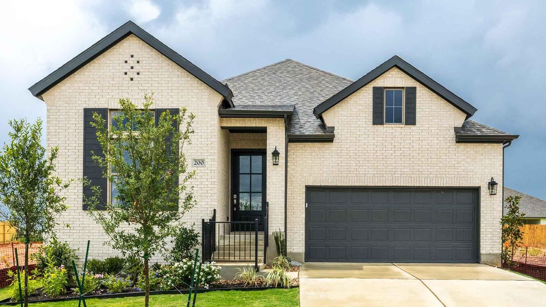 Front exterior of a new home in Santa Rita Ranch - Tierra Rosa, Liberty Hill, TX, highlighting curb appeal (Image 2). Front exterior of a new home in Santa Rita Ranch - Tierra Rosa, Liberty Hill, TX, highlighting curb appeal (Image 2).