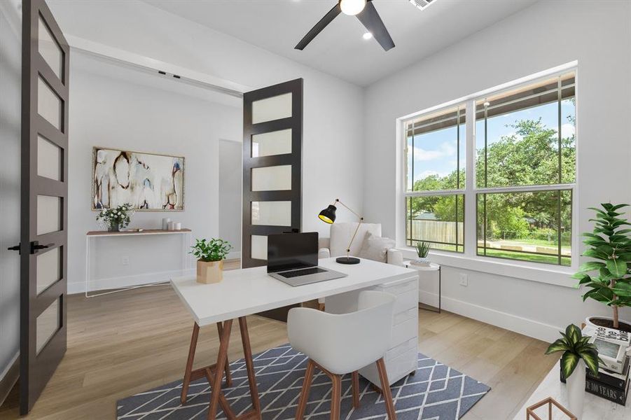 The study is on the lower level near the front door and overlooks the front yard. Virtually staged.