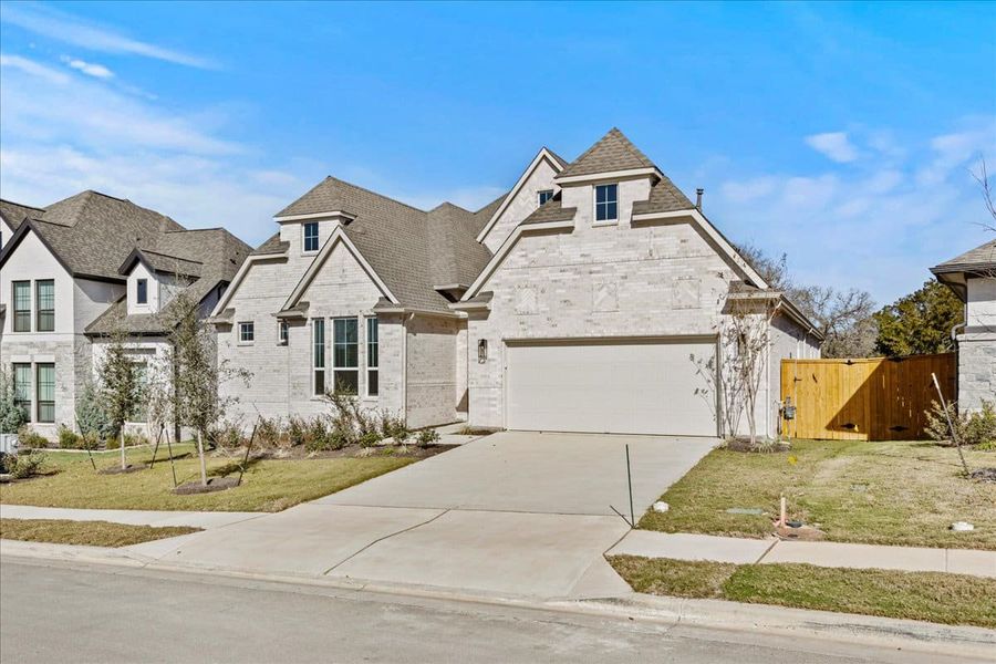 Front exterior of a new home in 6 Creeks, Kyle, TX, highlighting curb appeal (Image 17). Front exterior of a new home in 6 Creeks, Kyle, TX, highlighting curb appeal (Image 17).