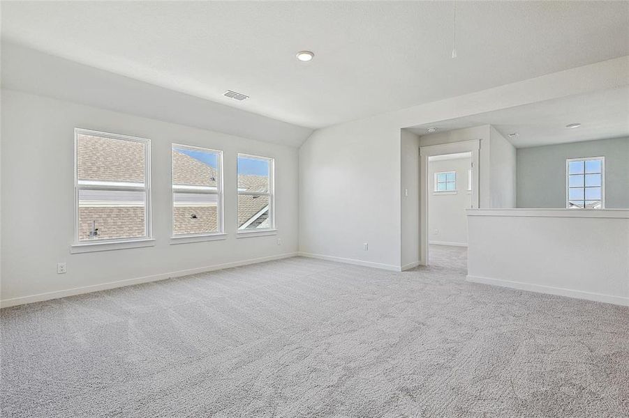 Empty room featuring light carpet