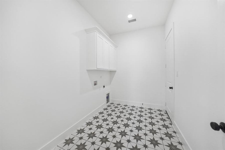 Washroom featuring light flooring, hookup for an electric dryer, cabinet space, washer hookup, and recessed lighting