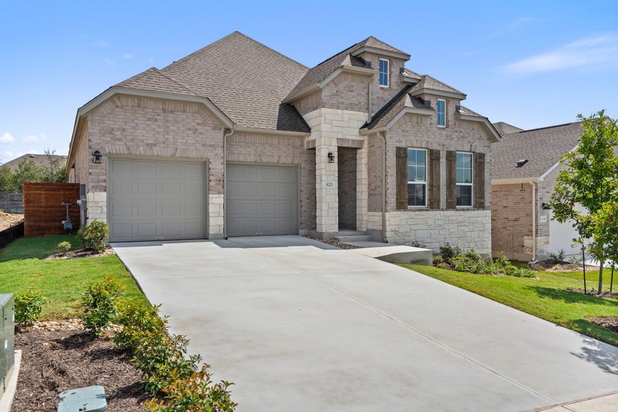 Representative exterior photo of a completed home built from the Waterville by Ashton Woods in The Trails at Carmel, Pflugerville, TX (Image 29).