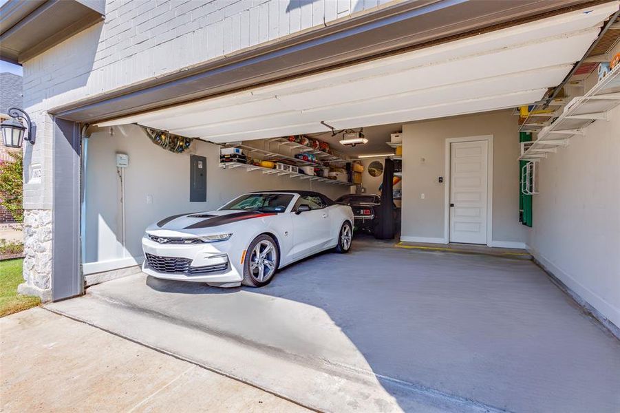 Oversized garage with lots of storage shelving Oversized garage with lots of storage shelving