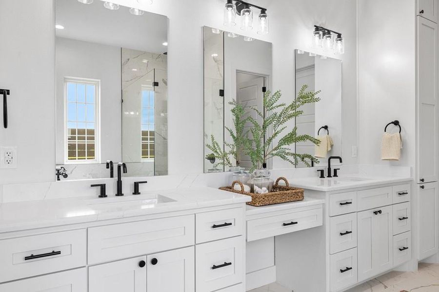Primary bath with double vanity, and large mirrors to reflect sunlight throughout room Primary bath with double vanity, and large mirrors to reflect sunlight throughout room