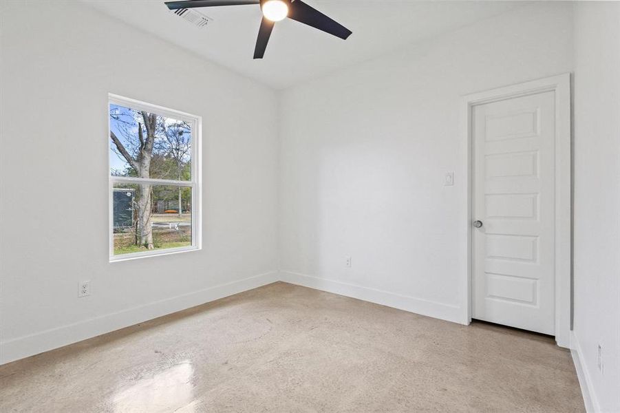 Unfurnished room with ceiling fan and baseboards