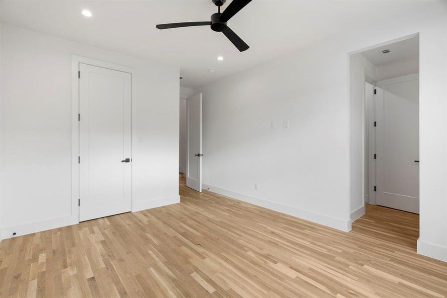 Unfurnished bedroom featuring recessed lighting, light wood finished floors, and ceiling fan Unfurnished bedroom featuring recessed lighting, light wood finished floors, and ceiling fan