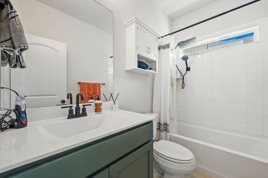 Bathroom with shower / tub combo and vanity