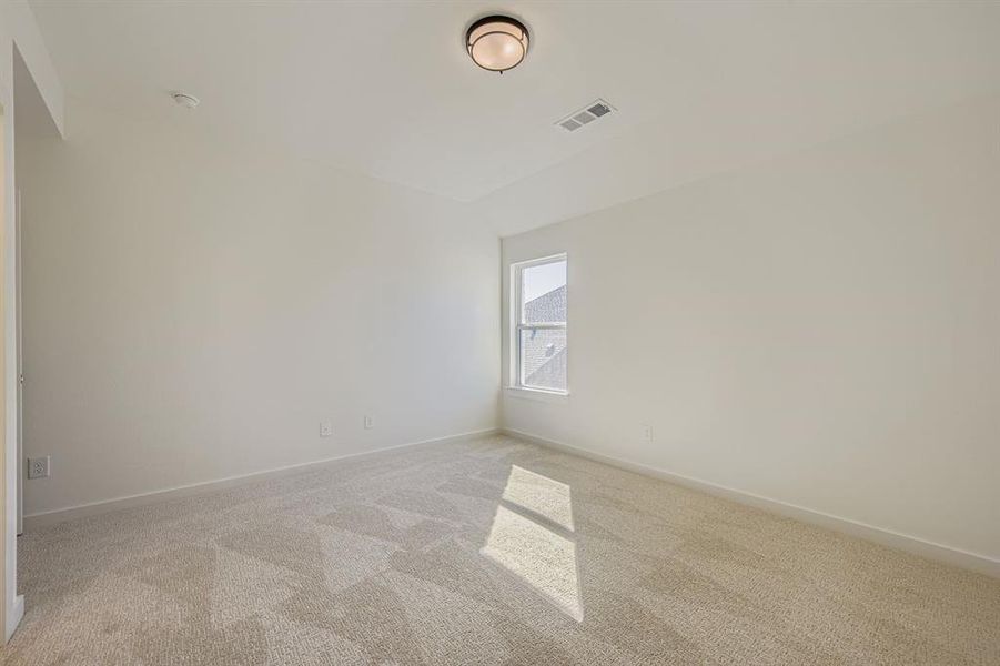 Carpeted empty room featuring baseboards