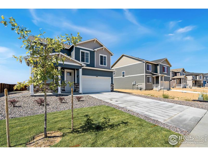 Front exterior of a new home in Vista Meadows, Fort Lupton, CO, highlighting curb appeal (Image 1).