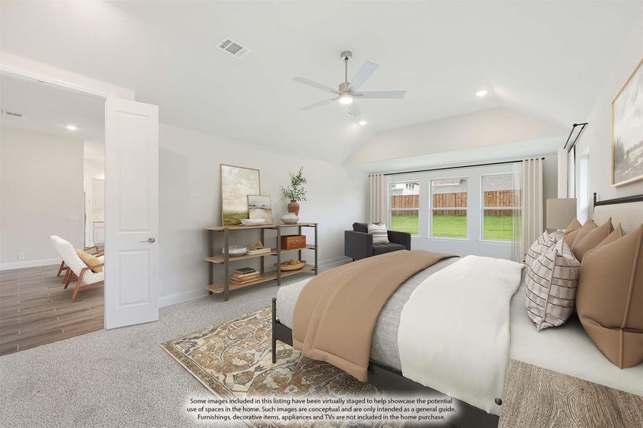 Bedroom with vaulted ceiling, ceiling fan, carpet flooring, and large windows overlooking backyard