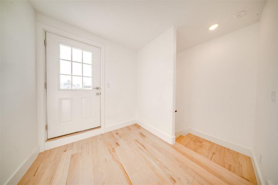 Doorway to outside with wood-type flooring