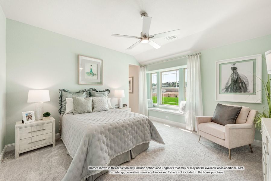 Bedroom with vaulted ceiling, ceiling fan, window seat, and light green walls with carpet flooring Bedroom with vaulted ceiling, ceiling fan, window seat, and light green walls with carpet flooring