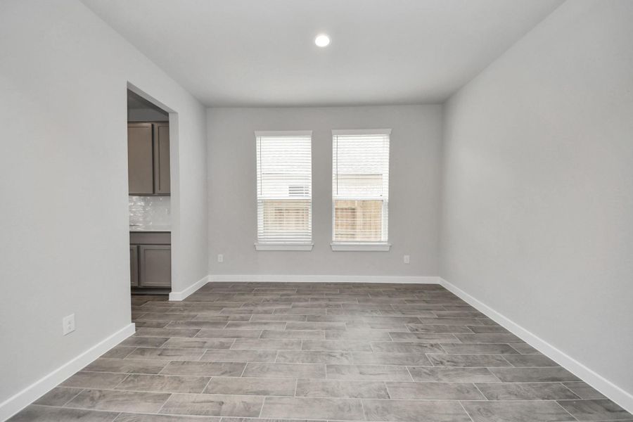 Make memories gathered around the table with your family and friends! This spacious diningroom features elegant flooring, custom paint, and adjacent to family room and kitchen foropen concept feel.