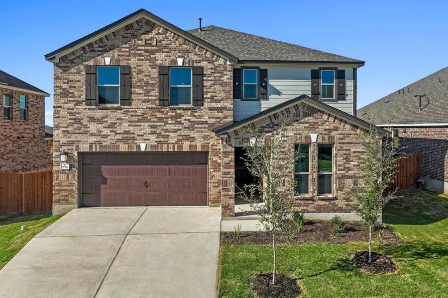 Front exterior of a new home in Salerno - Classic Collection, Round Rock, TX, highlighting curb appeal (Image 1). Front exterior of a new home in Salerno - Classic Collection, Round Rock, TX, highlighting curb appeal (Image 1).