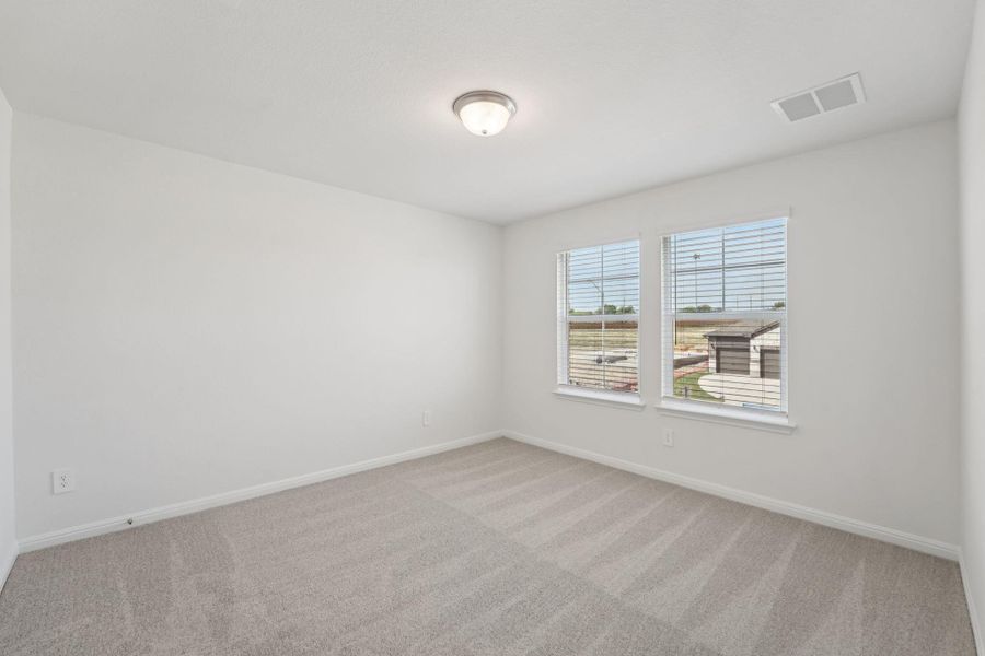 Unfurnished room featuring light carpet and baseboards