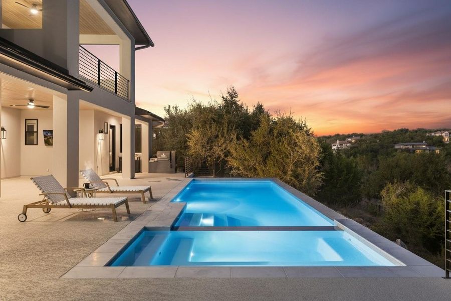 Elevated outdoor living space featuring a two-story residence with covered patios