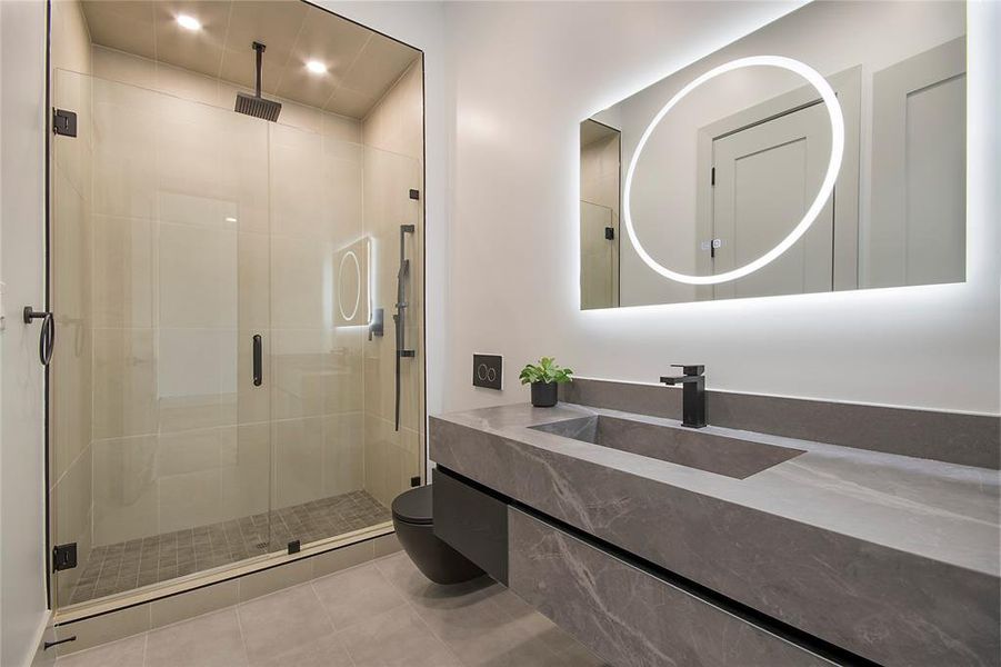 Bathroom with vanity, a stall shower, tile patterned floors, and recessed lighting