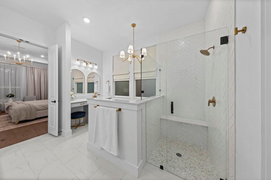 Bathroom with an enclosed shower, vanity, and a chandelier