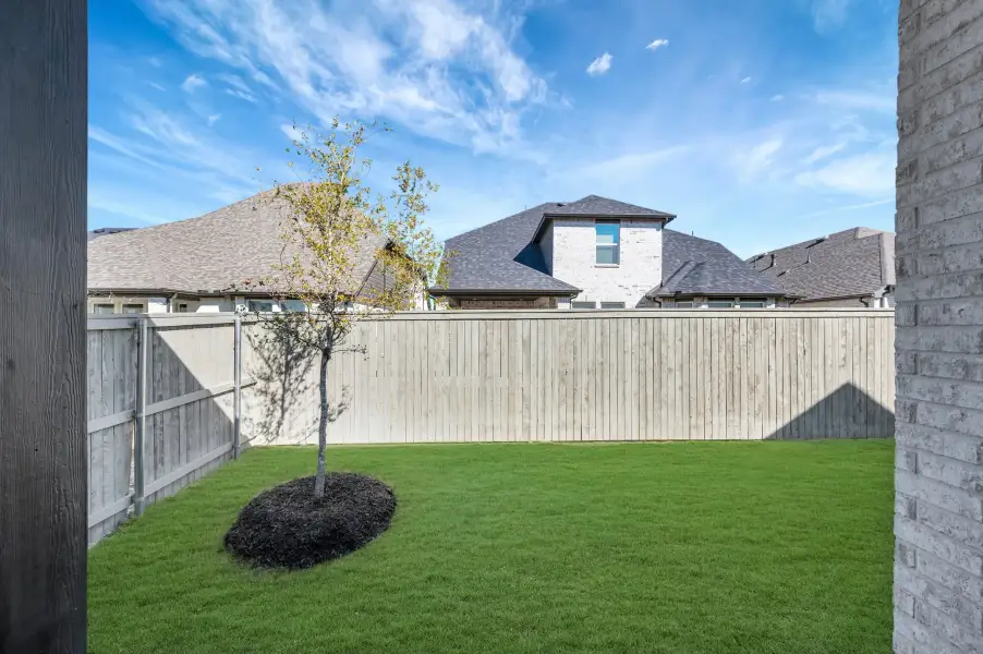 Exterior details and patio area of a home in Pecan Square - Gardens, Northlake (Image 3).