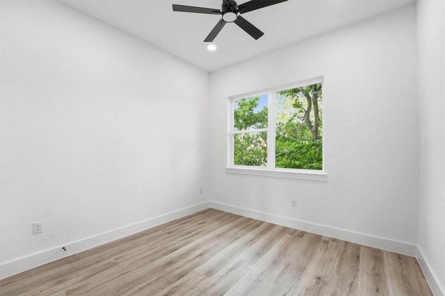 Spacious secondary bedroom with large windows for additional natural light.