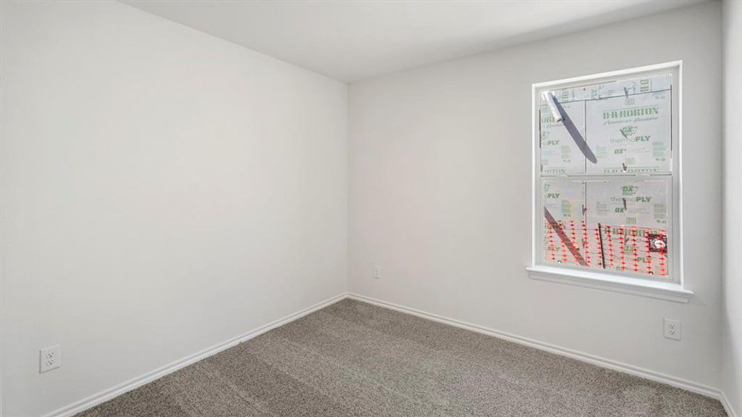 Neutral-toned carpeting and white walls create a versatile interior space