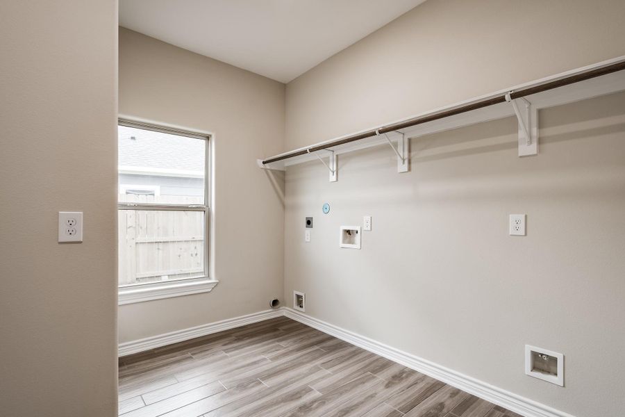 Spacious laundry area with storage space. Spacious laundry area with storage space.