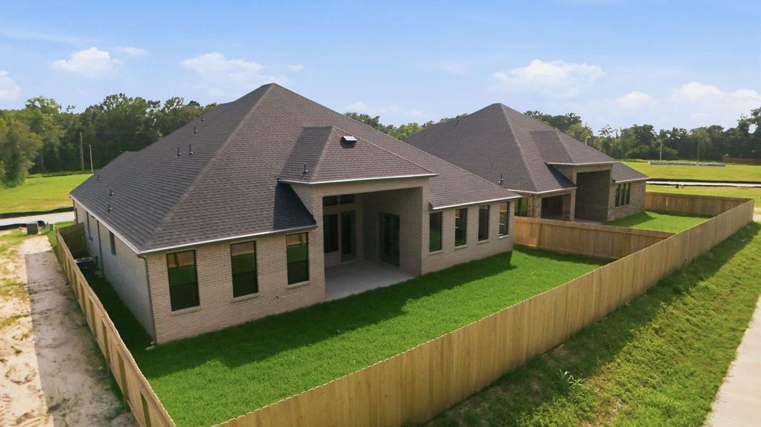 Large fenced-in backyard with a covered patio, perfect for outdoor entertaining.