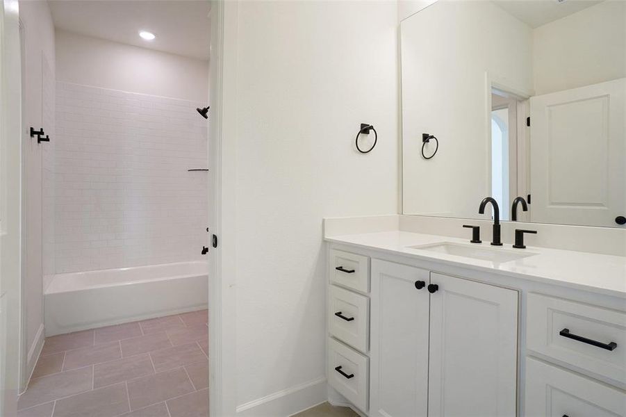 Bathroom with vanity, shower / bathtub combination, and recessed lighting Bathroom with vanity, shower / bathtub combination, and recessed lighting