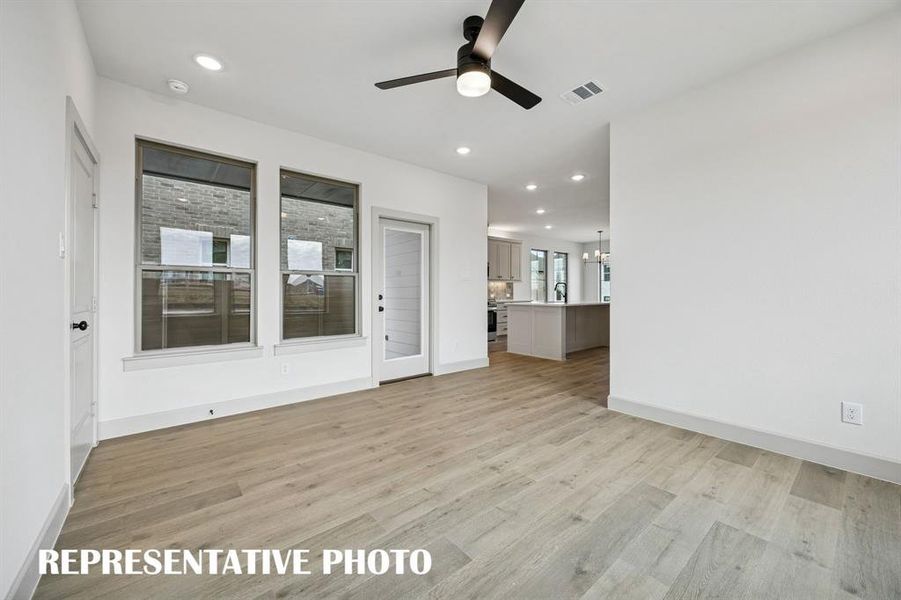 Spacious and inviting, this family room offers a wonderful space for family gatherings.  REPRESENTATIVE PHOTO