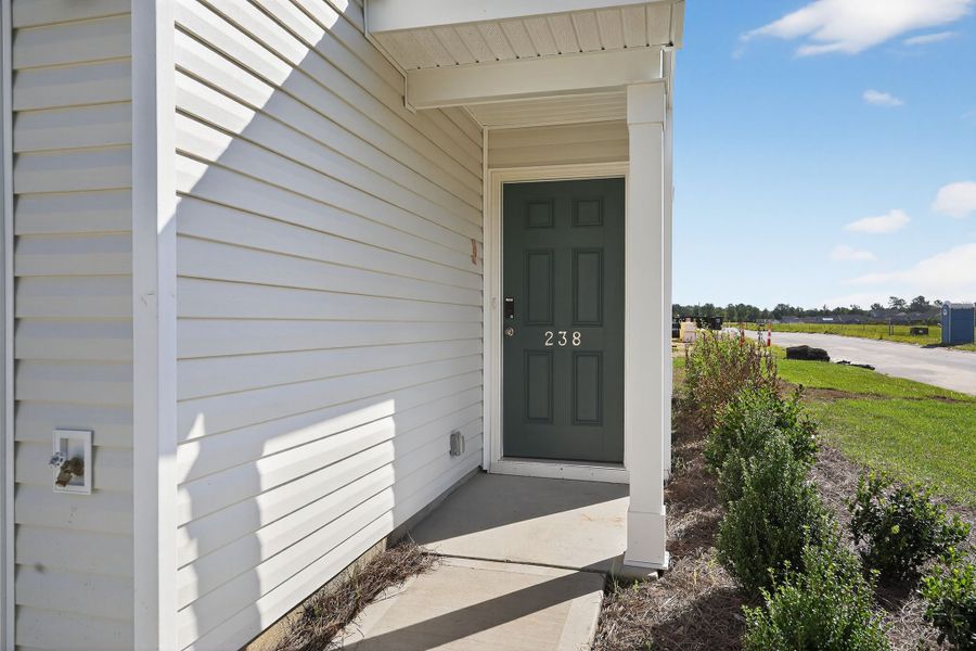 A white house with a green door.