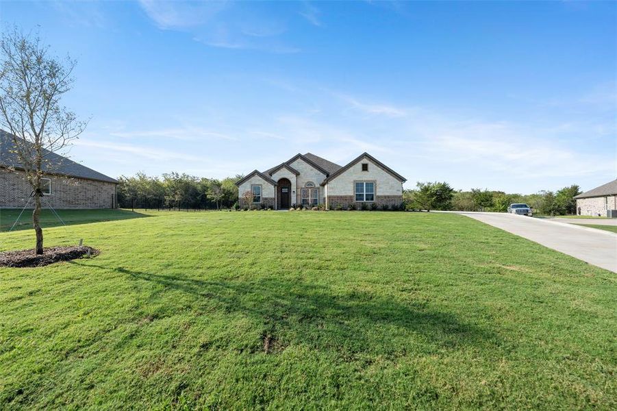 Front exterior of a new home in Vista Oaks Estates, Royse City, TX, highlighting curb appeal (Image 26).