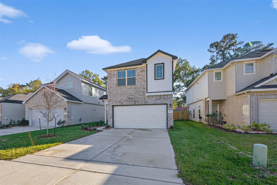 Front exterior of a new home in Woodland Lakes, Huffman, TX, highlighting curb appeal (Image 1). Front exterior of a new home in Woodland Lakes, Huffman, TX, highlighting curb appeal (Image 1).