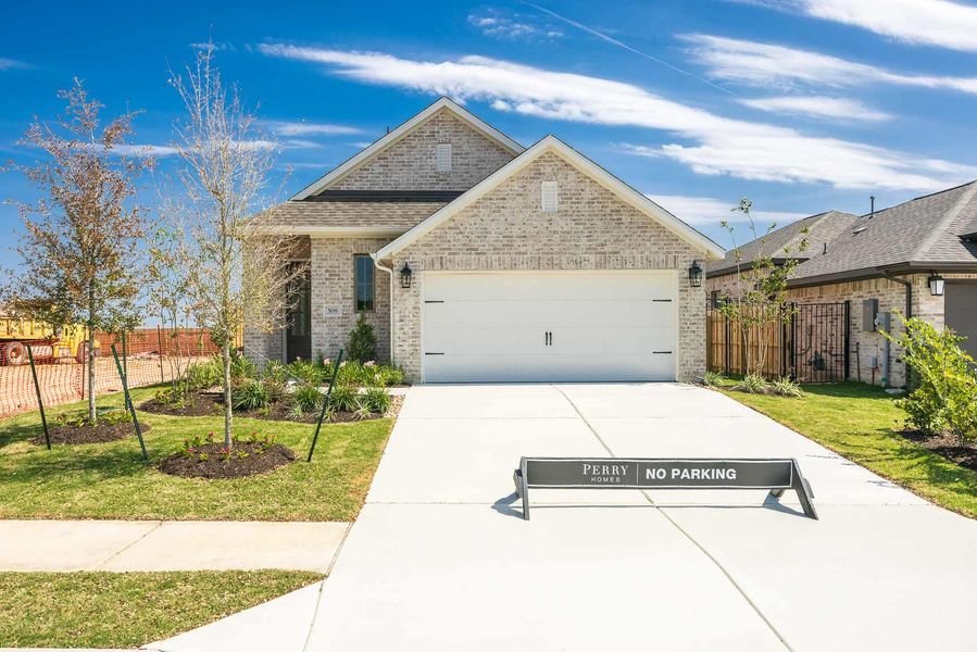 View of front of home featuring brick siding, a garage, and driveway View of front of home featuring brick siding, a garage, and driveway