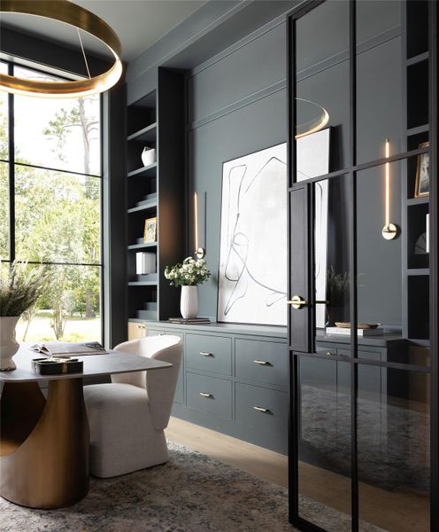 Custom built-ins and double iron doors lead into the home office or study, where a large window overlooking the front motor court creates an inviting and inspiring workspace. Custom built-ins and double iron doors lead into the home office or study, where a large window overlooking the front motor court creates an inviting and inspiring workspace.