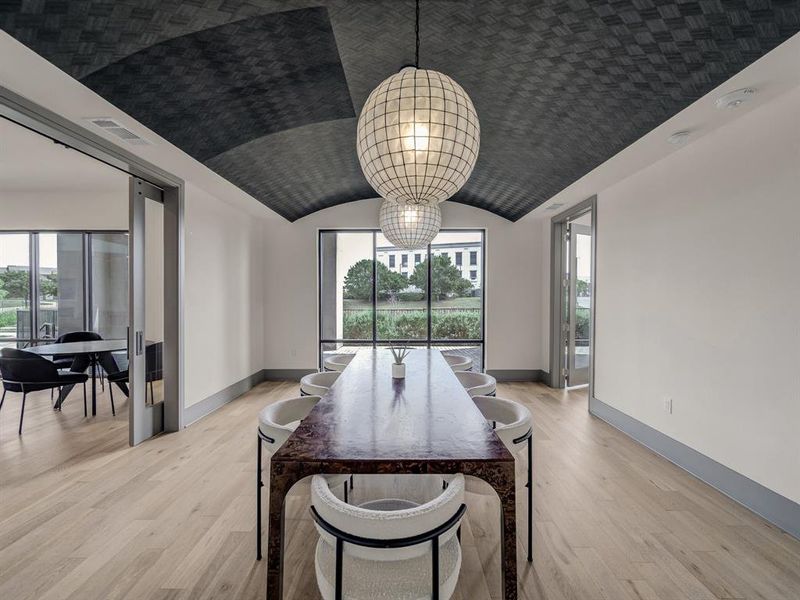 Dining space featuring plenty of natural light, light wood-type flooring, and lofted ceiling Dining space featuring plenty of natural light, light wood-type flooring, and lofted ceiling