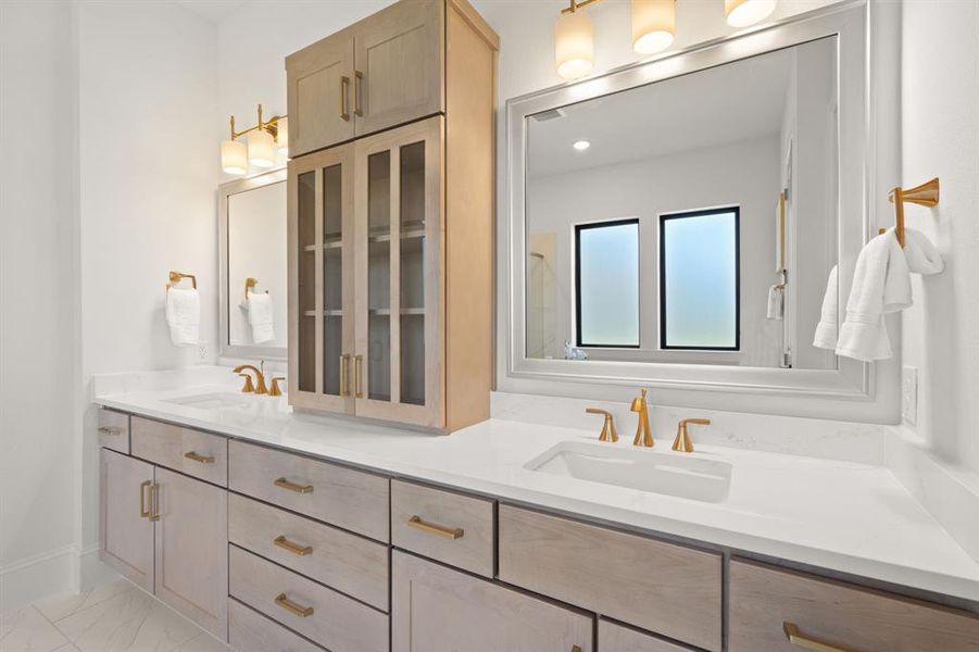 Double sinks in ensuite owner's bath, with gold hardware affixed to Kent Moore's Reclaimed Drift on Maple cabinets