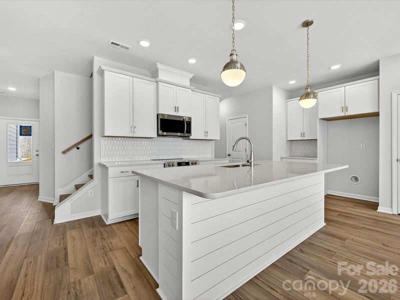 Shiplap Island- Quartz countertops, 42" cabinets with soft close doors and drawers, tiled backsplash, solid shelving in pantry, Frigidaire gallery appliances. cooking is vented to the outside