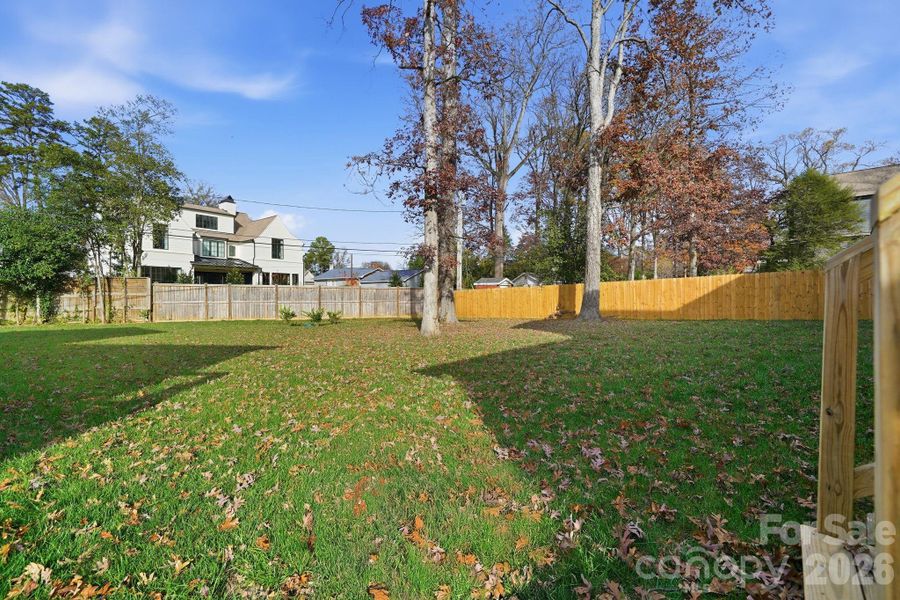 A wide view of the lush tree-lined yard that provides complete privacy. A wide view of the lush tree-lined yard that provides complete privacy.