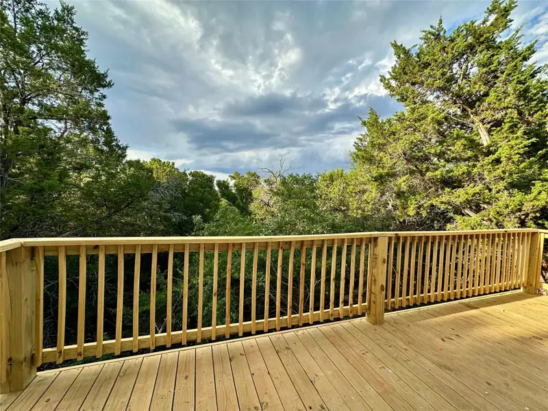 Wooden deck with a wooded view