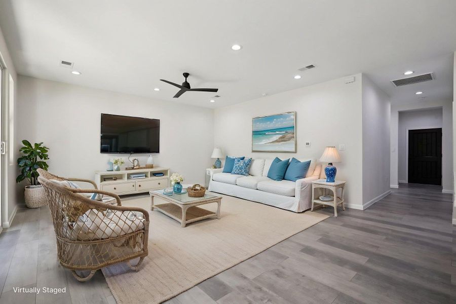 Virtually Staged Living room with light wood-type laminate flooring, recessed lighting, and ceiling fan